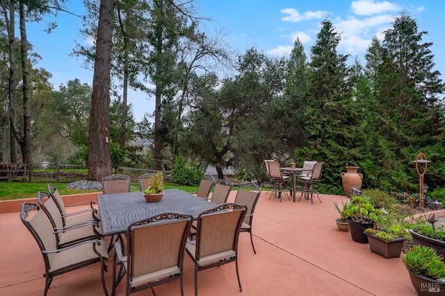 view of patio featuring outdoor dining area and fence