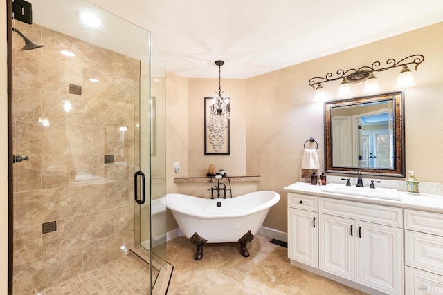 bathroom with vanity, baseboards, a shower stall, and a freestanding bath