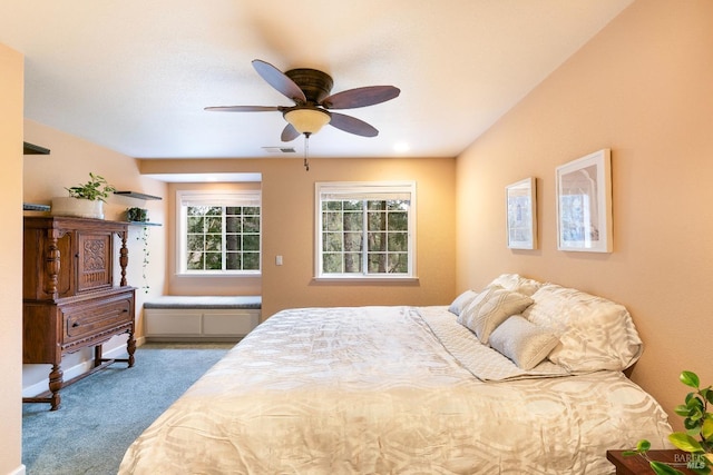 carpeted bedroom with visible vents and a ceiling fan