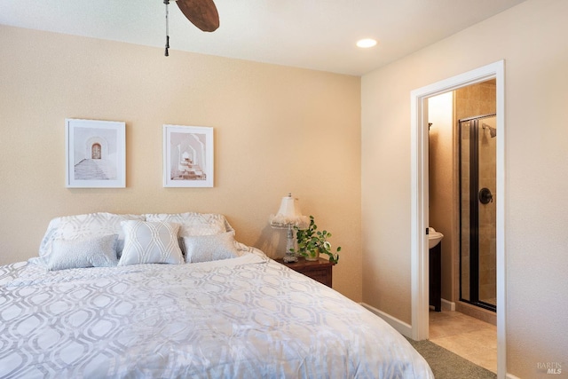 tiled bedroom with baseboards, connected bathroom, and a ceiling fan