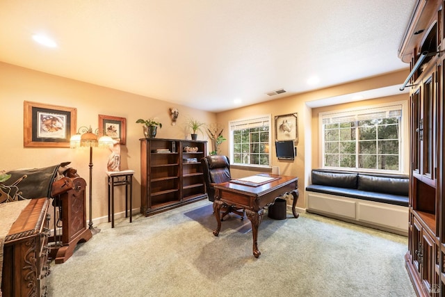 carpeted home office featuring baseboards and visible vents