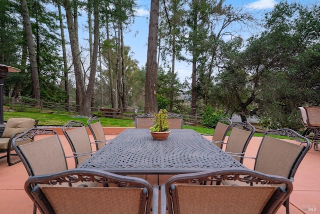 view of patio with outdoor dining space and fence