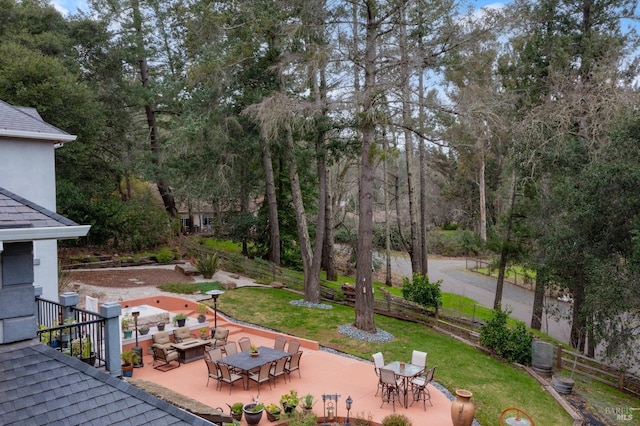 view of yard with outdoor dining area, fence, and a patio area