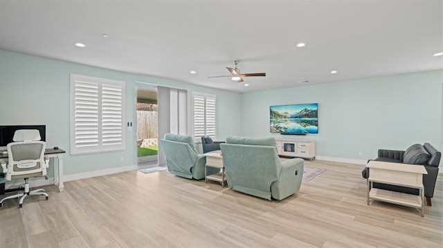 living room with recessed lighting, baseboards, and light wood finished floors