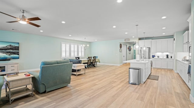 955 Vasey St, Winters, CA 95694 - kitchen with open floor plan, a center island with sink, light wood-type flooring, light countertops, and recessed lighting