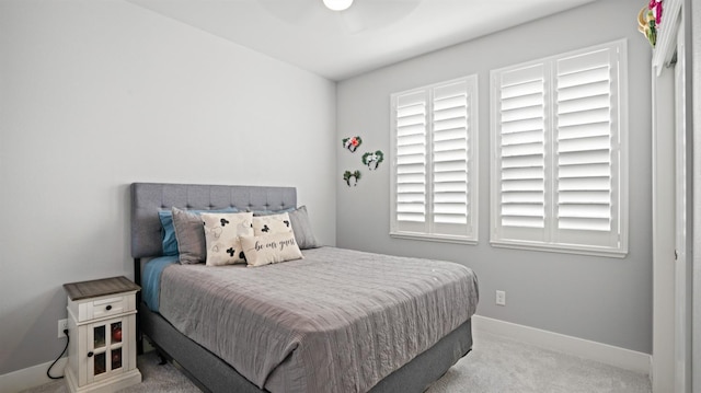 carpeted bedroom featuring a ceiling fan and baseboards