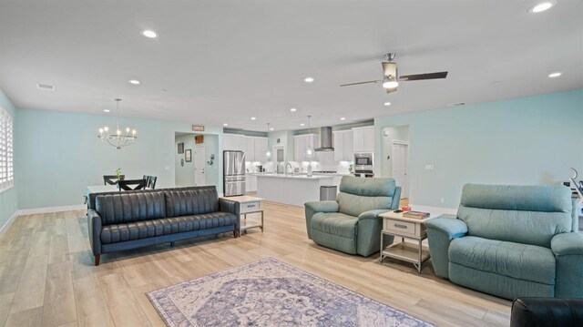 955 Vasey St, Winters, CA 95694 - living room featuring a chandelier, light wood-style floors, ceiling fan, recessed lighting, and baseboards