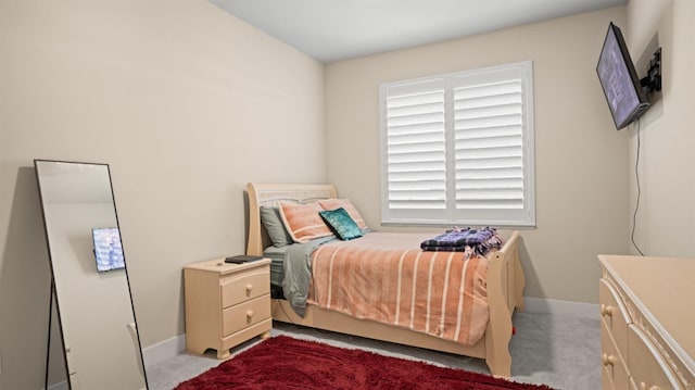 bedroom featuring carpet and baseboards