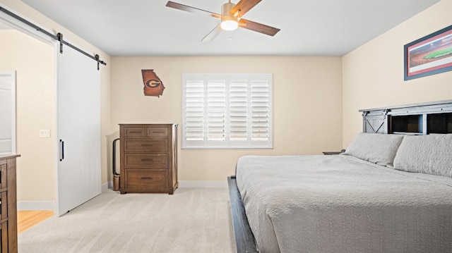 955 Vasey St, Winters, CA 95694 - bedroom with a barn door, baseboards, light colored carpet, and ceiling fan