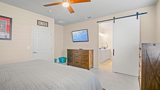 955 Vasey St, Winters, CA 95694 - bedroom with a barn door, carpet, ceiling fan, and ensuite bathroom