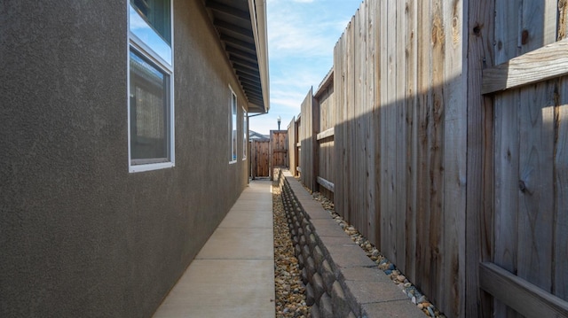 view of property exterior featuring fence and stucco siding