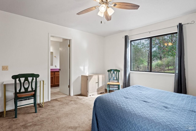 carpeted bedroom with ceiling fan and ensuite bath