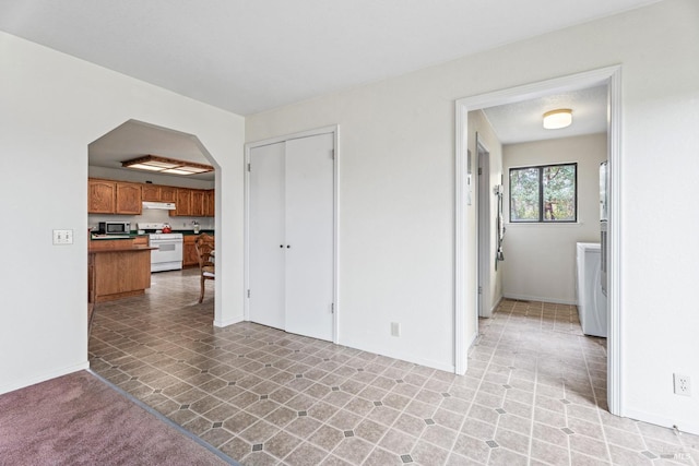 unfurnished living room with washer and clothes dryer