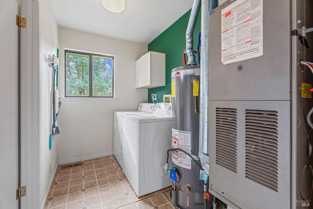 laundry area with washer and dryer, cabinets, water heater, and heating unit