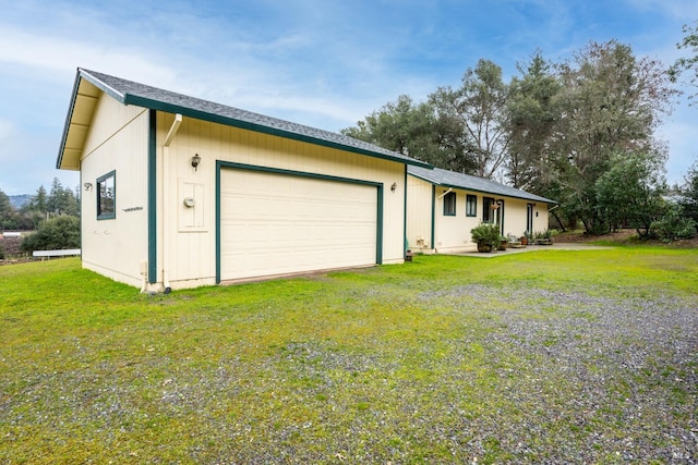 single story home with a front yard and a garage