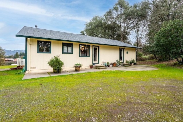 back of house with a lawn