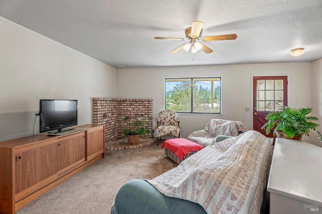 carpeted bedroom featuring a textured ceiling and ceiling fan