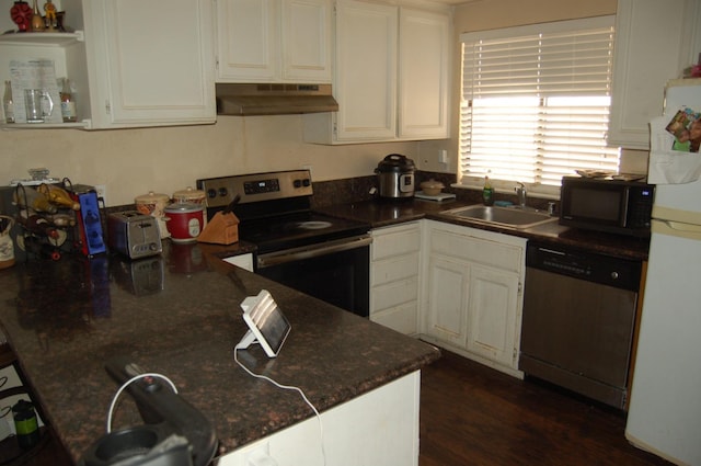 kitchen with under cabinet range hood, dark wood-type flooring, a sink, white cabinets, and appliances with stainless steel finishes