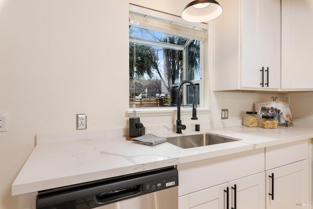 kitchen with dishwasher, sink, light stone counters, and white cabinets