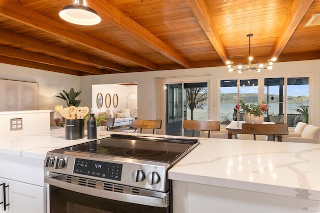 kitchen with stainless steel range with electric stovetop, beam ceiling, light stone counters, and decorative light fixtures