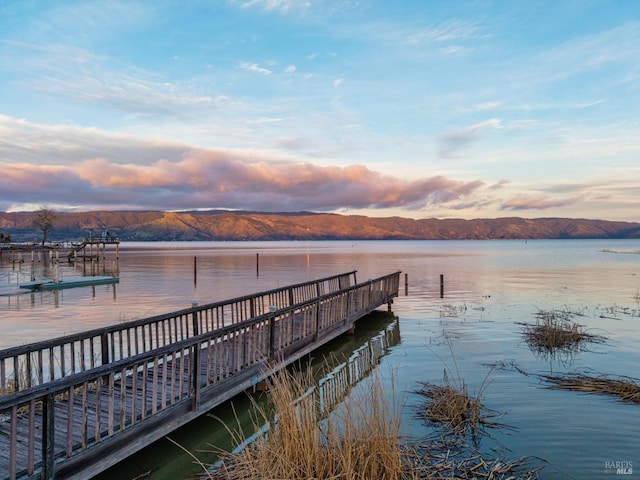 view of dock featuring a water and mountain view