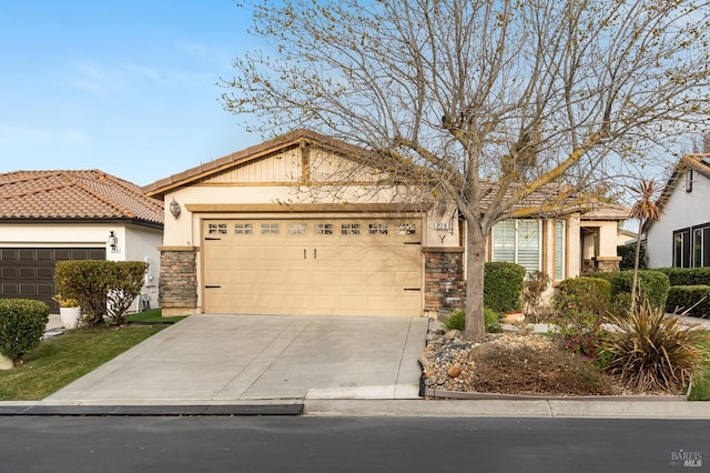 view of front of home with driveway, stone siding, a tiled roof, an attached garage, and stucco siding