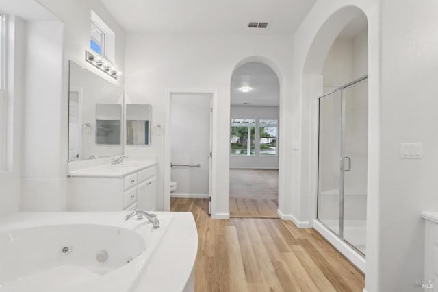 full bathroom with separate shower and tub, wood-type flooring, vanity, and toilet