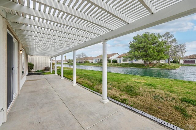 view of patio / terrace featuring a pergola and a water view