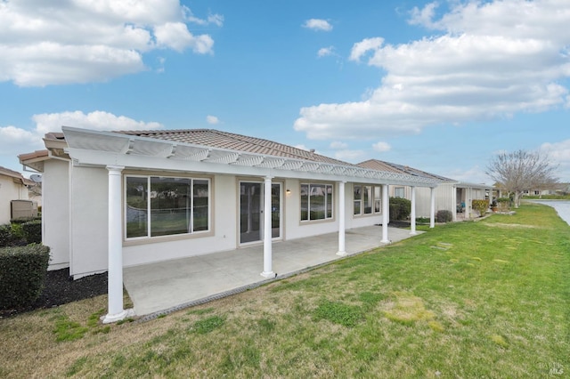 rear view of property featuring a patio, a yard, and a pergola