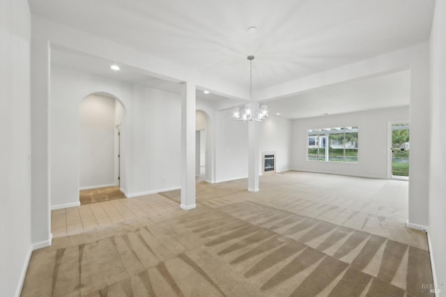 interior space with light carpet and a chandelier