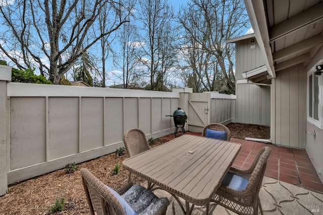 view of patio / terrace featuring area for grilling, outdoor dining area, and a fenced backyard