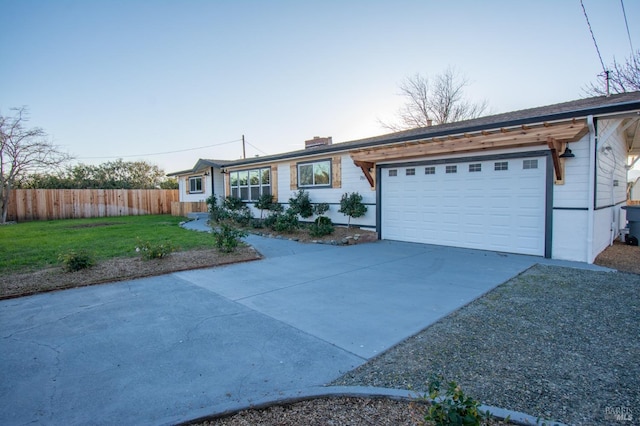 ranch-style home featuring a garage and a front yard