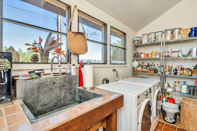 washroom with a sink, independent washer and dryer, and laundry area