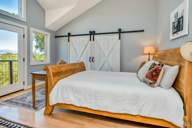 2020 Felta Rd, Healdsburg, CA 95448 - bedroom with a barn door, access to exterior, wood finished floors, and lofted ceiling