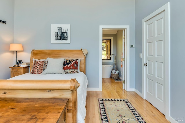 bedroom with light wood-type flooring and baseboards