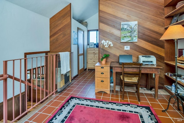 office featuring tile patterned floors and wooden walls