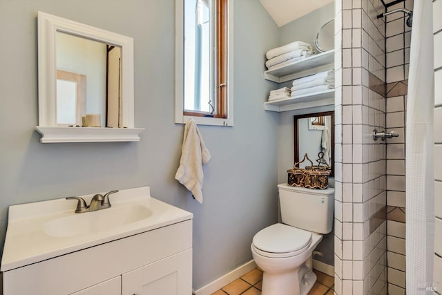 bathroom featuring vanity, baseboards, a tile shower, tile patterned floors, and toilet