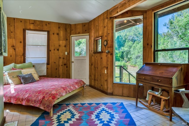 tiled bedroom featuring lofted ceiling and wood walls