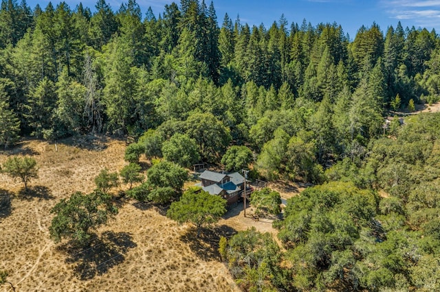 drone / aerial view featuring a forest view