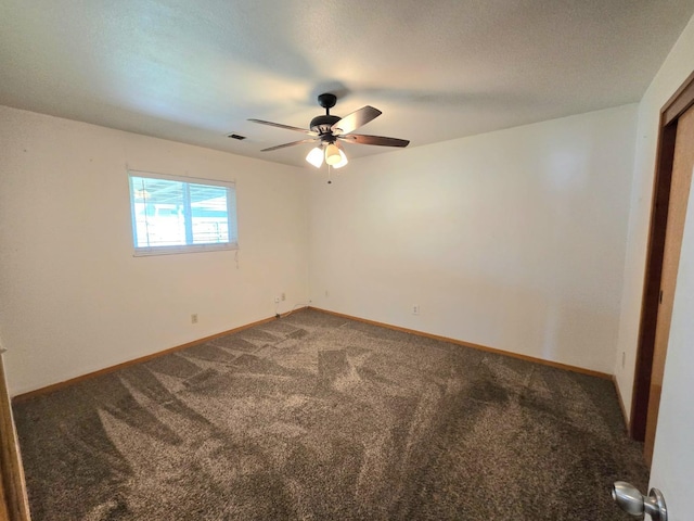 spare room featuring carpet flooring, ceiling fan, a textured ceiling, and baseboards