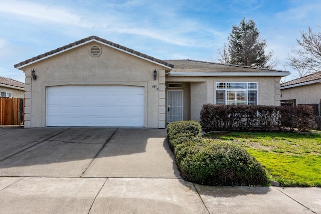 single story home featuring a tile roof, stucco siding, a garage, driveway, and a front lawn