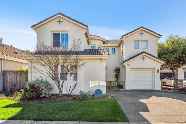 mediterranean / spanish-style home featuring concrete driveway, a tile roof, fence, and stucco siding