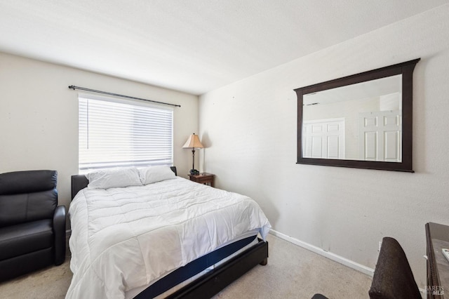 carpeted bedroom featuring baseboards