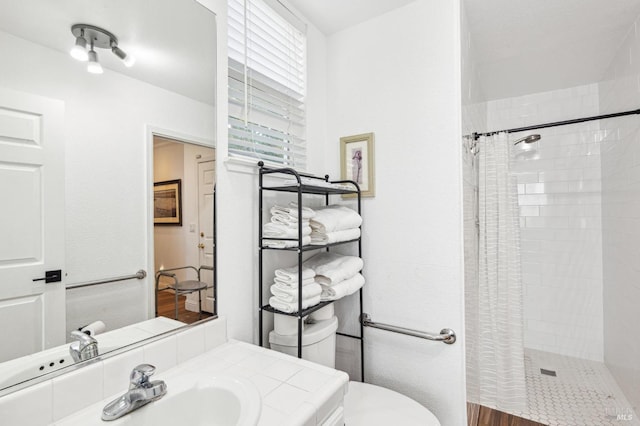 full bath featuring a stall shower, vanity, and toilet