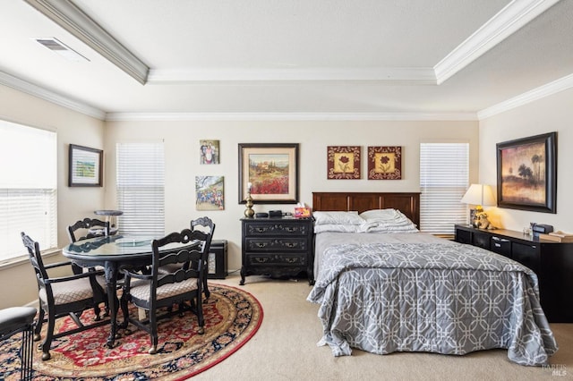 bedroom with carpet floors, a tray ceiling, visible vents, and ornamental molding