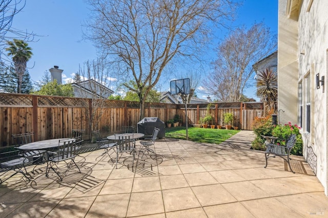 view of patio with a fenced backyard and outdoor dining space