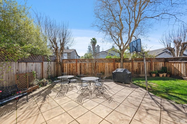 view of patio / terrace featuring outdoor dining space, a fenced backyard, and a grill