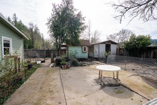 view of patio with a storage shed, an outdoor structure, and a fenced backyard