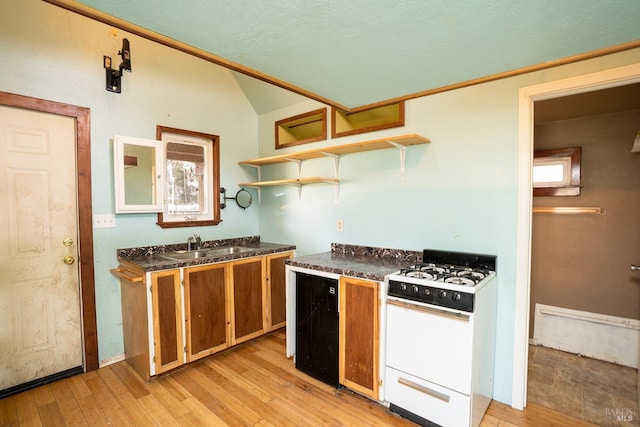 kitchen with brown cabinets, white gas range, vaulted ceiling, light wood-style floors, and open shelves