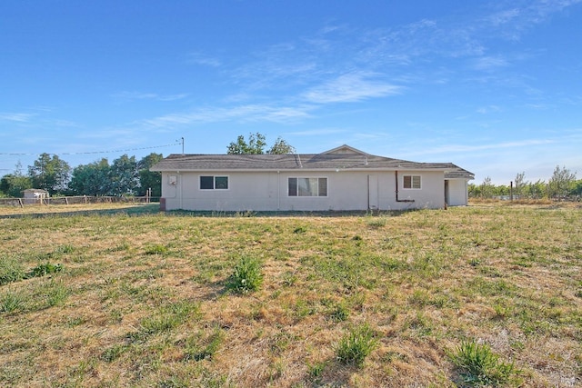 view of front facade featuring a front yard and fence